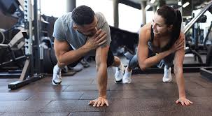 Sculpting Sleek Arms: The Essential Role of Cardio in Toning Without Bulking Up 1 Image of man and woman doing Cardio Royal Leamington Spa to tone their arms.